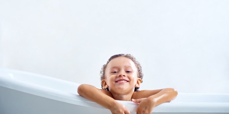 Kid smiling in bathtub