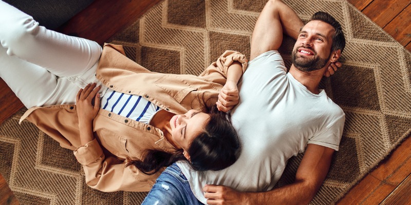 Couple lying on floor - Everything You Need to Know About Switching Away from Oil Heating 